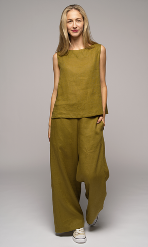Woman wearing a olive green singlet top and pants.