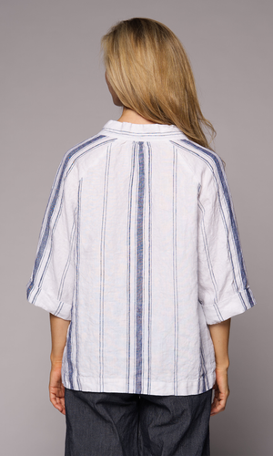 Close-up of a blonde woman's back wearing a collared top and denim pants.