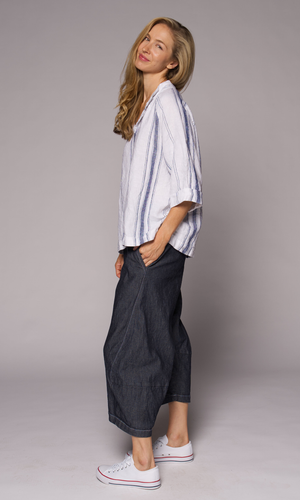 Blonde women wearing a collared top with denim pants.