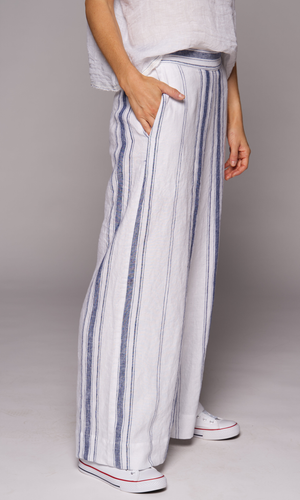 Close up of white linen-blue striped pants, hand in pocket.