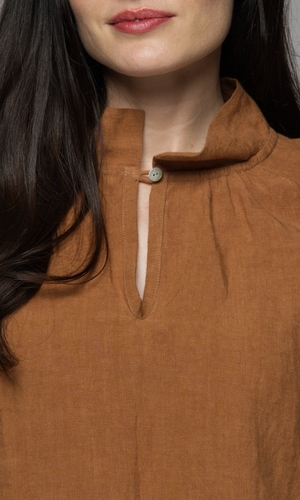 A close up of the neckline of a woman's top.