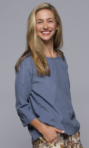 A woman wearing a blue shirt.