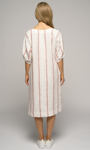 Woman wearing a white dress with red stripes, showing us the back of the dress.