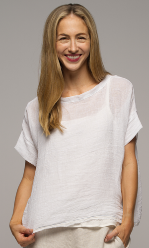 Closeup of a lady in short sleeve white top.
