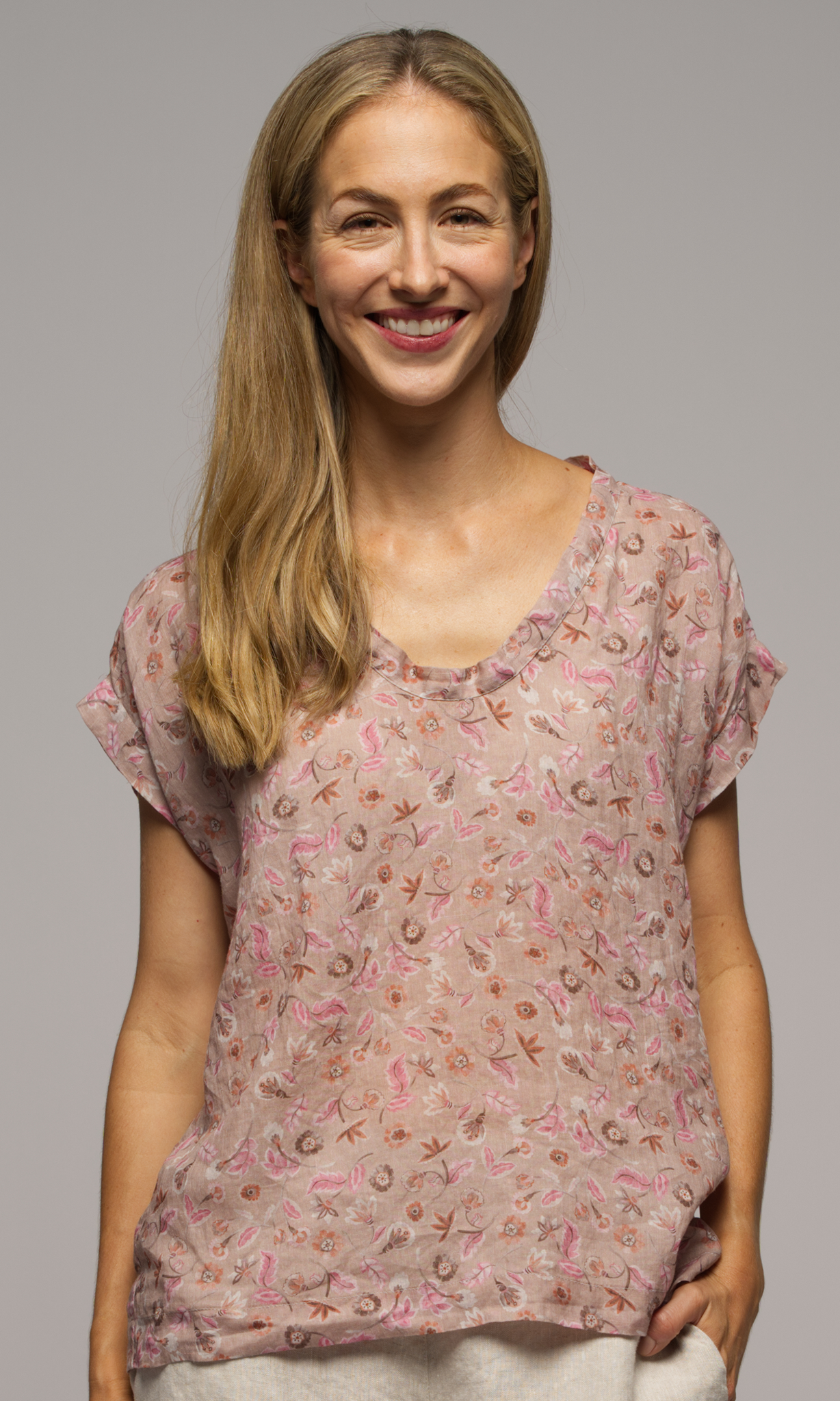 Lady wearing a short sleeve floral top.