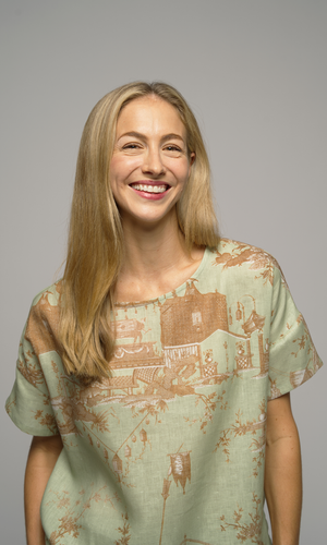 Woman wearing a light green patterned shirt.