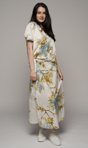 Woman wearing a floral short sleeve top and a floral skirt.